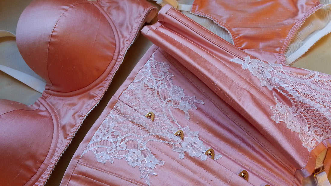 Close up of peach silk and ivory corset with matching lingerie