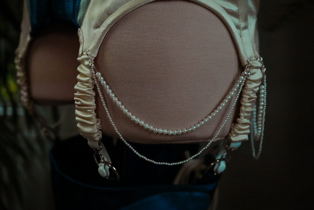 Close-up of pearl detail on suspenders