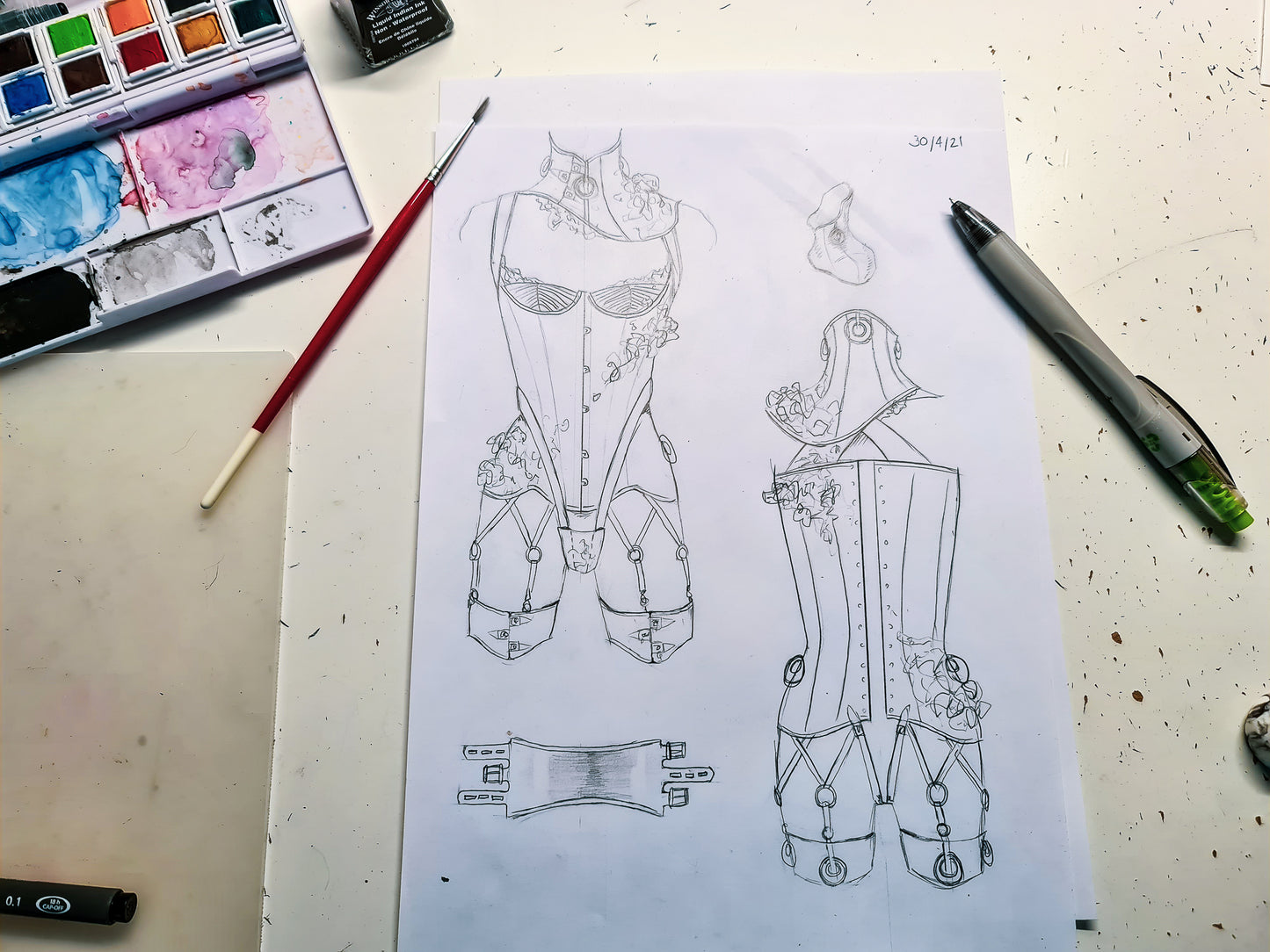 A sketch of a cupped overbust corset with matching neck corset and garters, decorated with 3D flowers