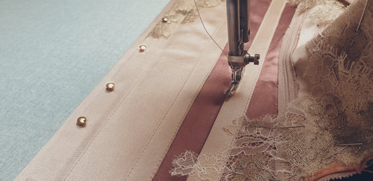 A silk corset being sewn 
