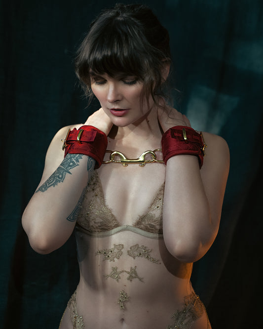 Model wears the red Morgan wrist cuffs with gold lingerie