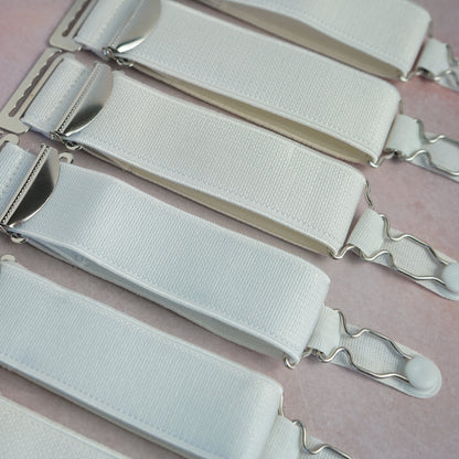 A set of 6 extra wide white suspenders with hooks