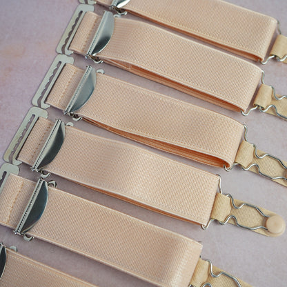 A set of 6 beige suspenders with hooks
